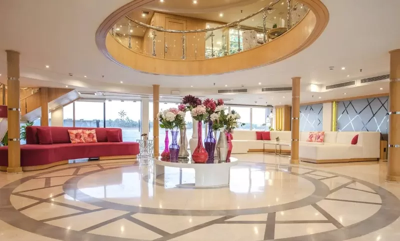 Luxury MS Acamar Nile Cruise gliding gracefully on the Nile – elegant white decks framed by golden sunlight