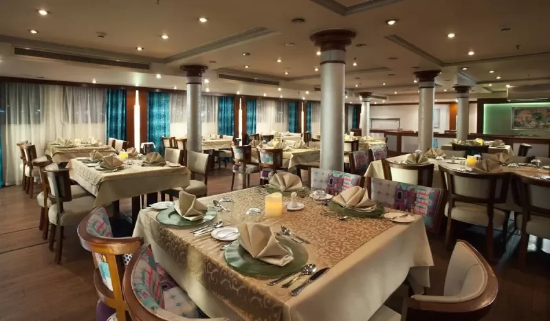 Luxury MS Acamar Nile Cruise lounge with comfortable seating and panoramic windows for serene river vistas