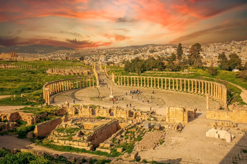 Roman colonnaded street and ancient arches at Jerash archaeological site.