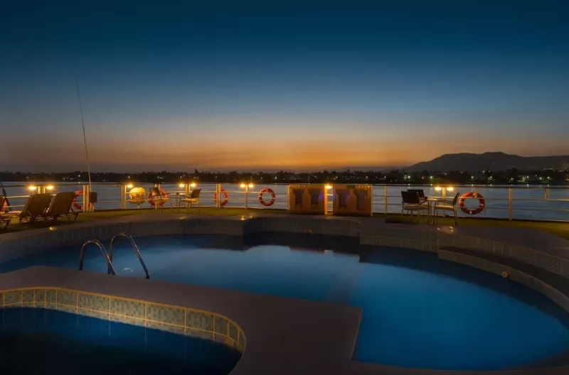 Relaxing on the sun deck of Steigenberger Royale Nile Cruise – pool, sun loungers and panoramic Nile vistas under open sky