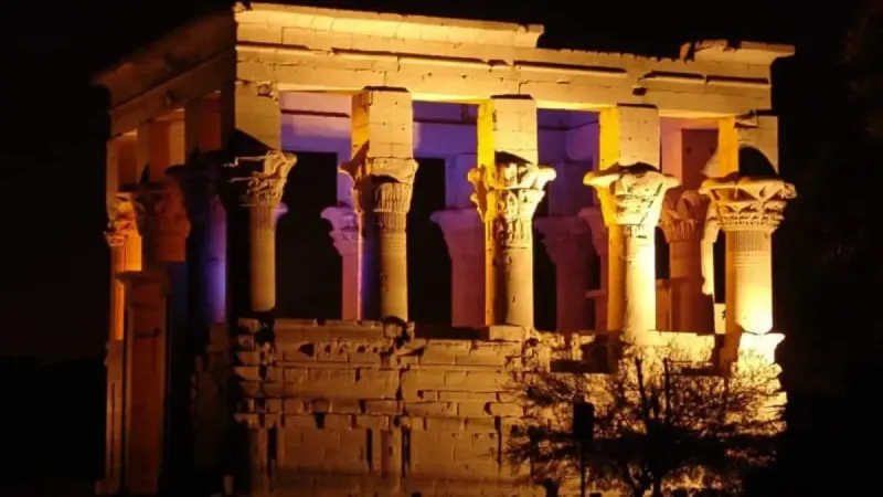 Ancient Philae Temple in Aswan Egypt glowing during the evening Sound and Light Show on Agilkia Island