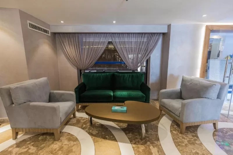 Spacious suite with elegant furniture and large windows on Semiramis II cruise