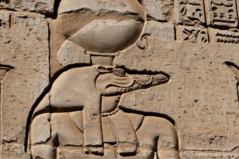 Visitors exploring the ancient Kom Ombo Temple on the banks of the Nile River in Egypt