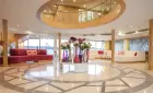 Luxury MS Acamar Nile Cruise gliding gracefully on the Nile – elegant white decks framed by golden sunlight