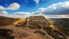 Historic Karak Castle in Jordan with medieval stone walls and panoramic views of the valley.