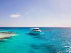 Tourists enjoying Marsa Alam holidays while spotting a Dugong at Marsa Mubarak lagoon.
