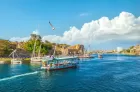 Visitors enjoying a felucca ride in Aswan Egypt with beautiful Nile River scenery and palm-covered islands
