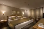 Luxurious cabin aboard Steigenberger Royale Nile Cruise – plush bedding and panoramic windows overlooking the river