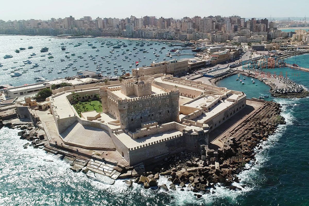 Visitors exploring the medieval walls and corridors of Qaitbay Citadel